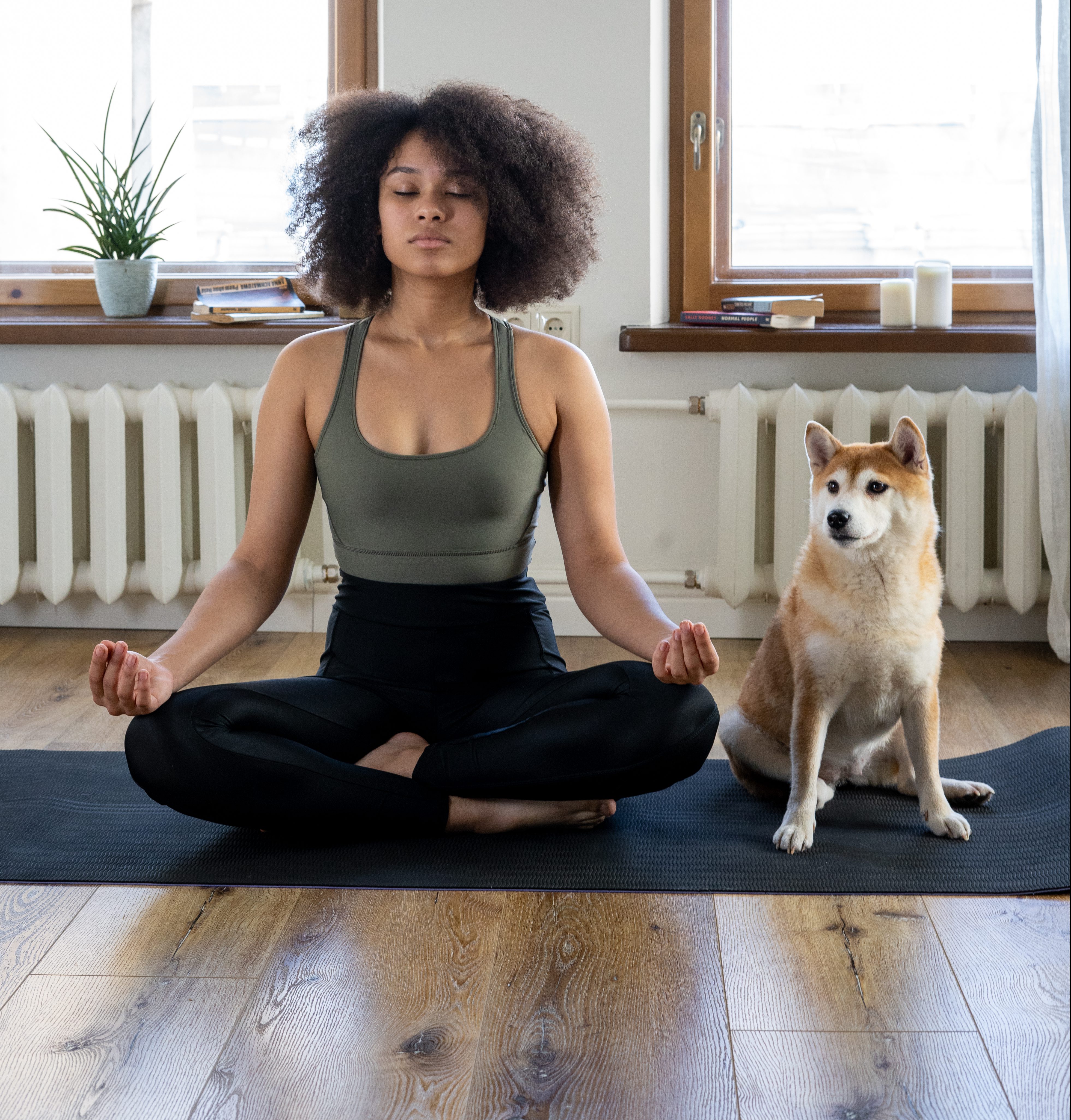 woman meditating with dog