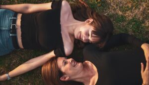 women laying on grass